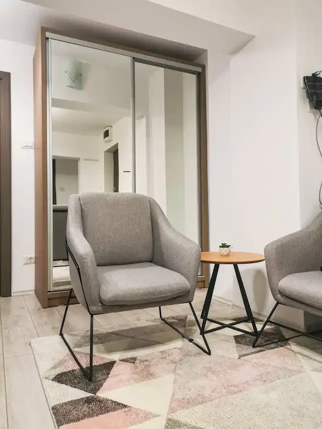 Stand-alone chairs in apartment with side table